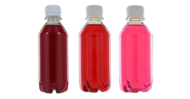 Three bottles of liquid coloured with natural colours. The first beverage is a deep red, the second is a true red, the third is a bright pink.